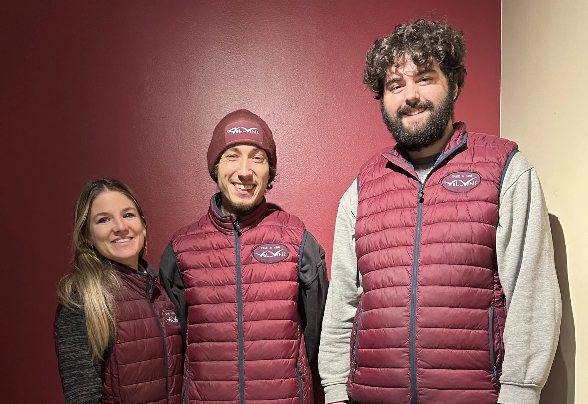 L’équipe de Vol aux Vins, souriante, en doudounes bordeaux brodées du logo de la cave.